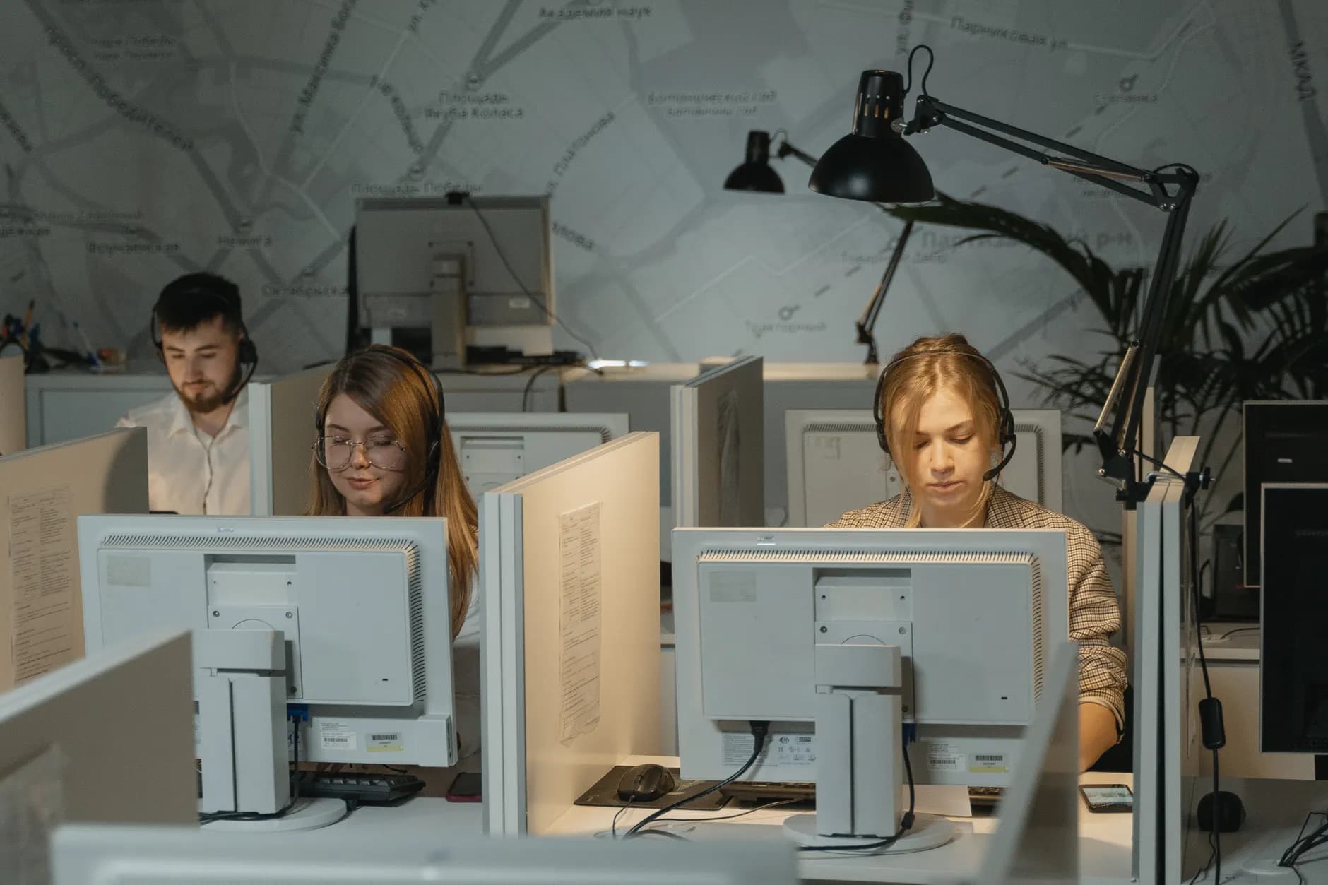Agents wearing headsets handling calls in a call centre.