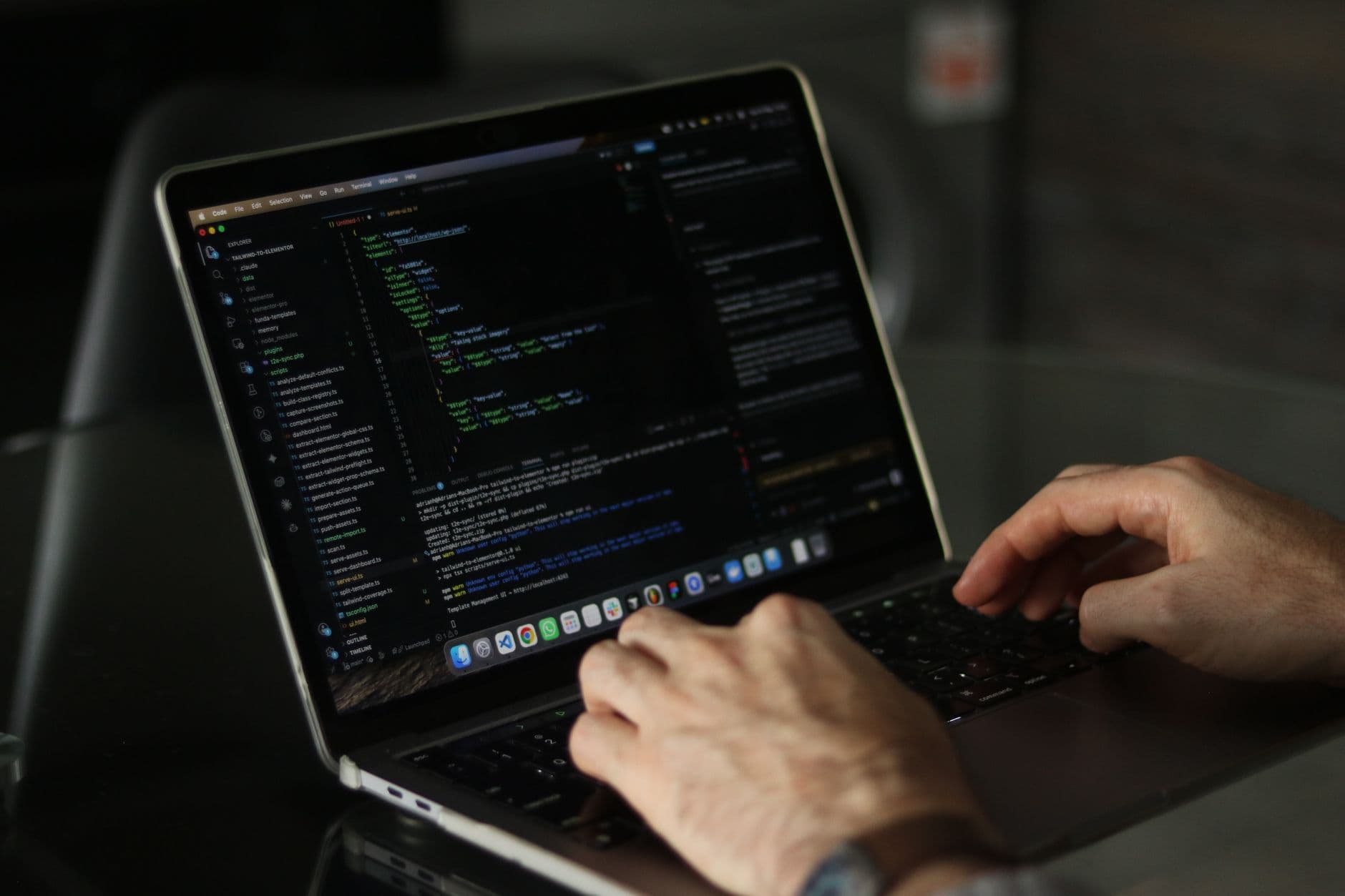 A developer writing code on a monitor