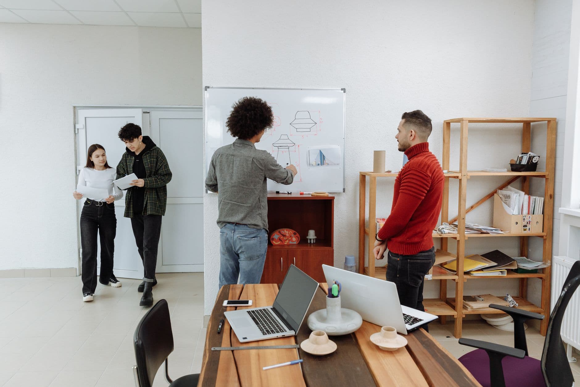 A small team reviewing a Next.js project on a whiteboard.