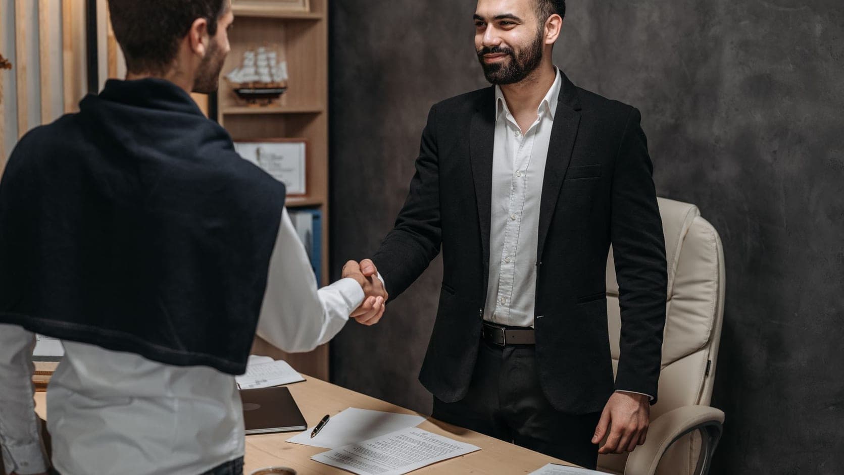 salesperson presenting product specs to engaged client across a table